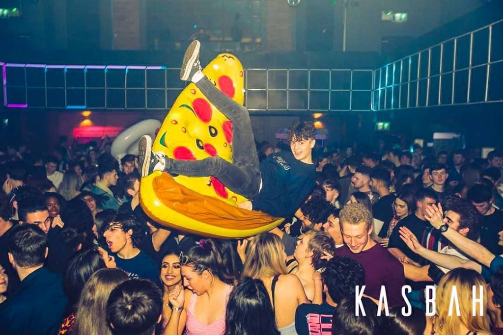 Kasbah man floating on a rubber pizza